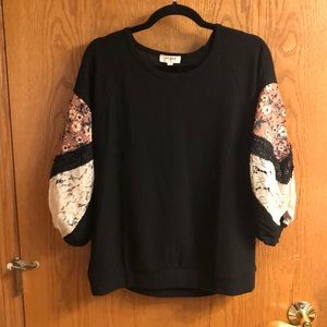 Black waffle knit top with blouson sleeves